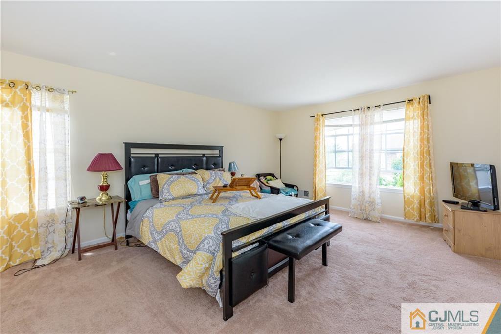 6 Yorkshire Village Road Lawrence Township, NJ 08648 - Photo 21 of 30 a bed room with a bed and a television