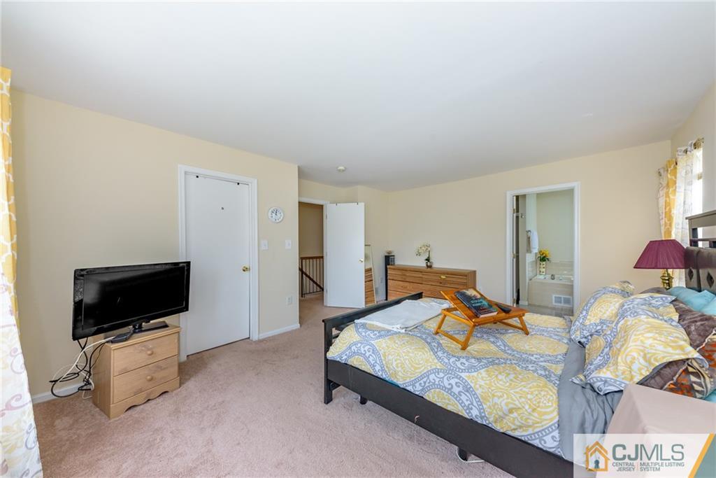 6 Yorkshire Village Road Lawrence Township, NJ 08648 - Photo 22 of 30 a bedroom with furniture and a flat screen tv
