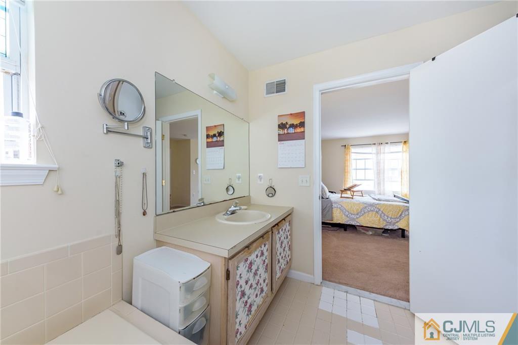 6 Yorkshire Village Road Lawrence Township, NJ 08648 - Photo 23 of 30 a bathroom with a tub sink and mirror