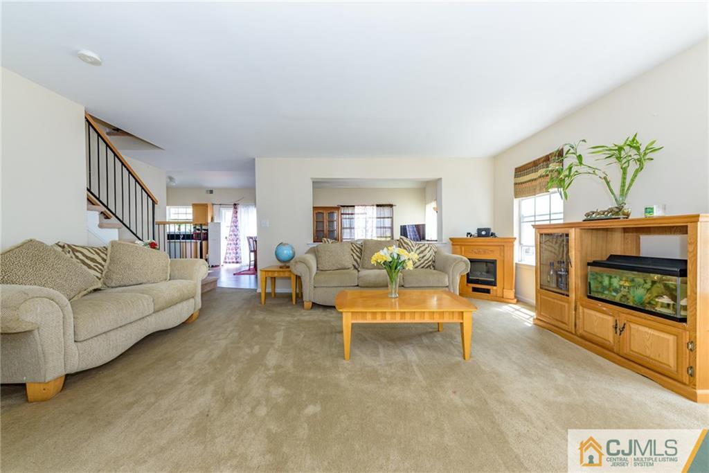 6 Yorkshire Village Road Lawrence Township, NJ 08648 - Photo 5 of 30 a living room with furniture a fireplace and a flat screen tv
