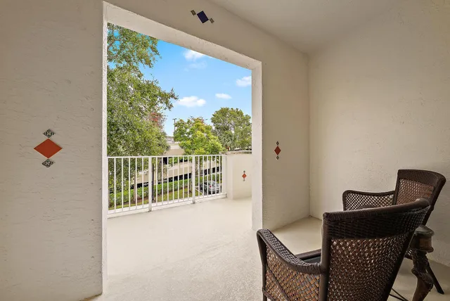 a balcony with table and chairs