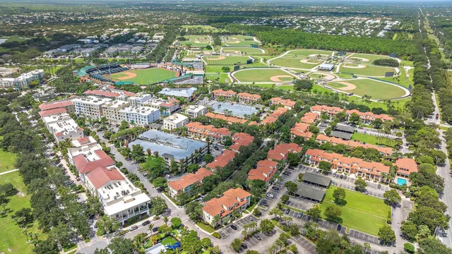 an aerial view of residential houses with outdoor space and river