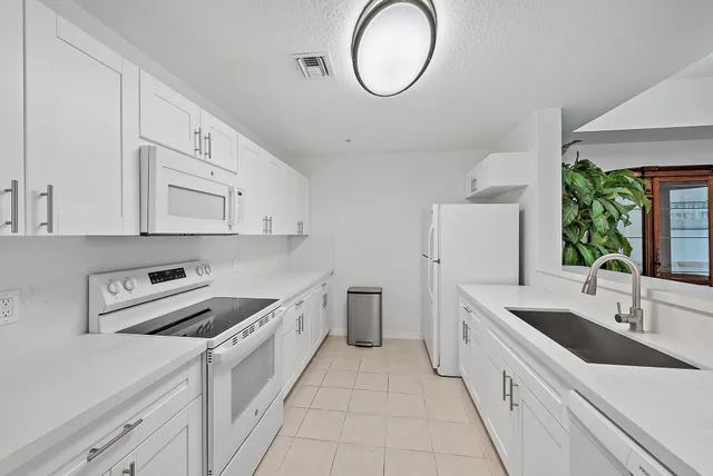 a kitchen with cabinets a sink and a stove