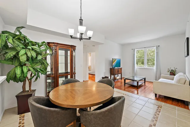 a living room with furniture a chandelier and a window