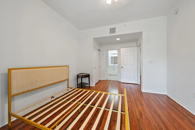 a view of a room with wooden floor and furniture