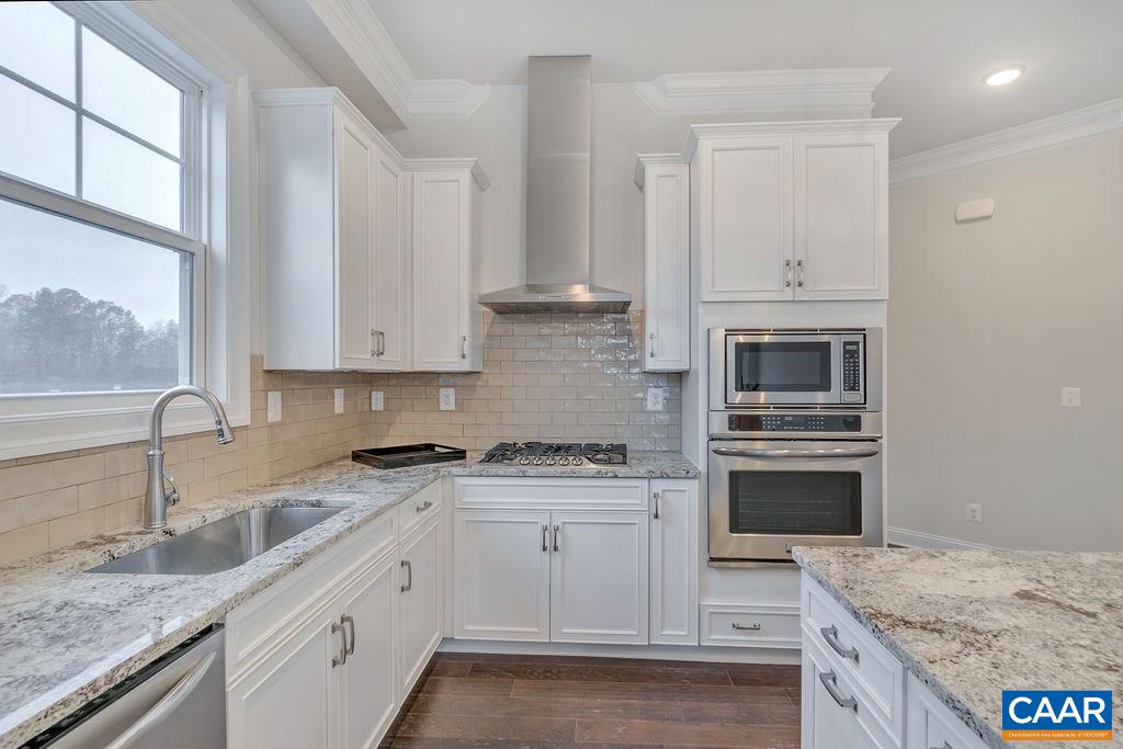 352 Claibourne Road Crozet, VA 22932 - Photo 19 of 28 a kitchen with granite countertop a sink stainless steel appliances and cabinets
