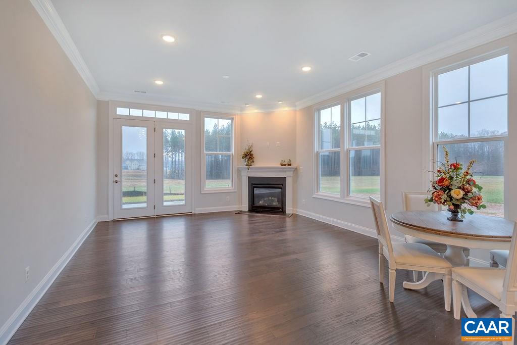 352 Claibourne Road Crozet, VA 22932 - Photo 21 of 28 a dining room with furniture wooden floor and a chandelier