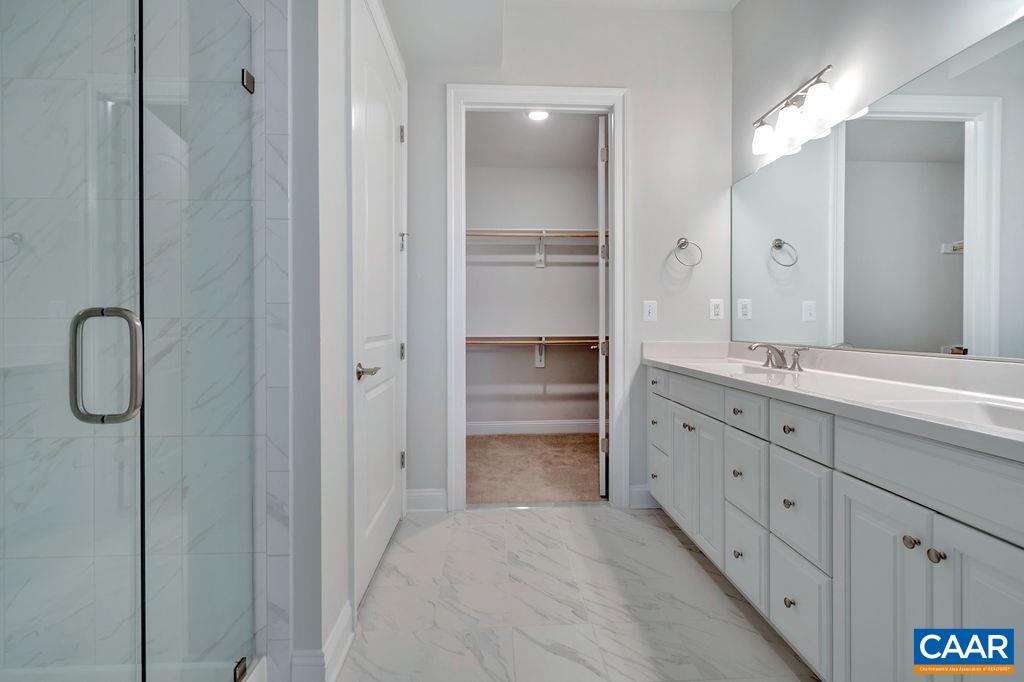 352 Claibourne Road Crozet, VA 22932 - Photo 25 of 28 a bathroom with a granite countertop sink two mirror and a shower