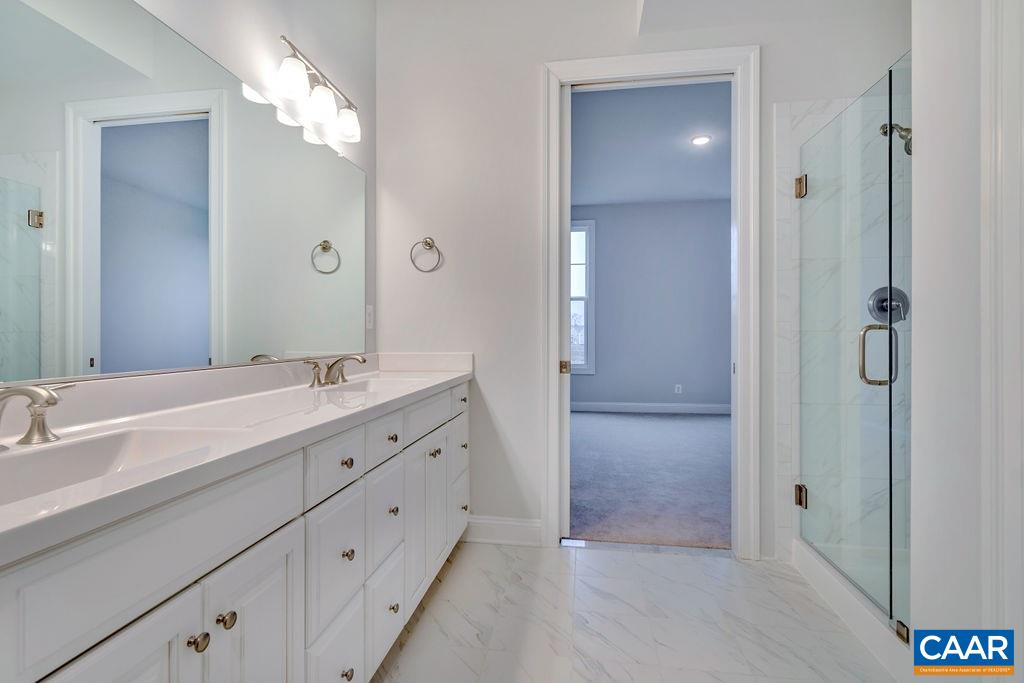 352 Claibourne Road Crozet, VA 22932 - Photo 28 of 28 a spacious bathroom with a double vanity sink shower and a mirror