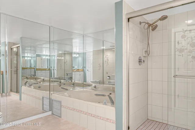 a bedroom with a bed and dresser with mirror