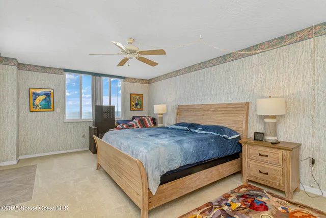 a bedroom with a bed and ceiling fan