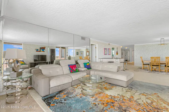 a view of a big room with windows and entryway