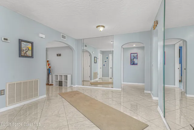 a bedroom with a bed mirror and a window