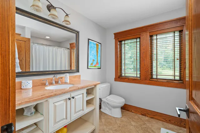 a spacious bathroom with a double vanity sink a mirror and a bathtub