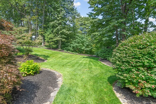 a living room with furniture a window and a chandelier