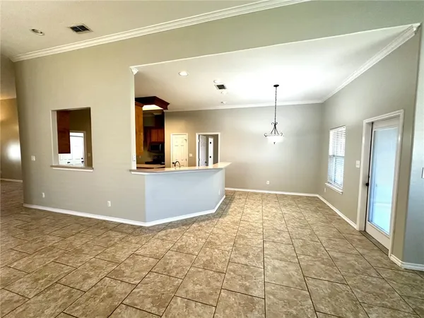 a view of a kitchen with a sink and a chandelier