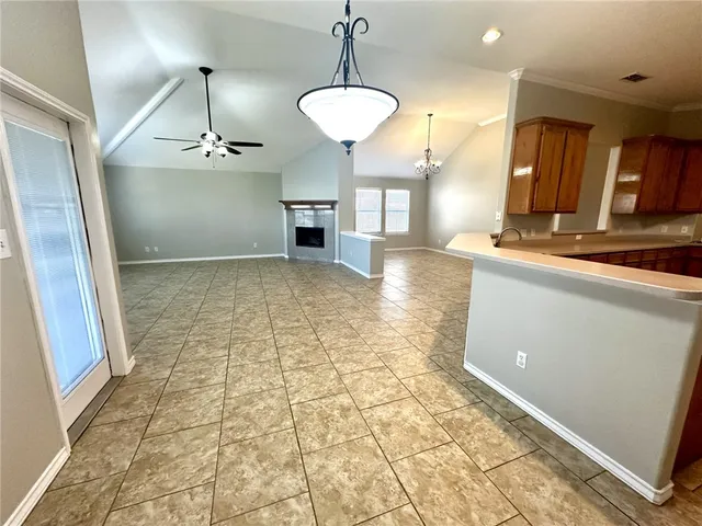 a kitchen with stainless steel appliances granite countertop a sink a stove and a refrigerator