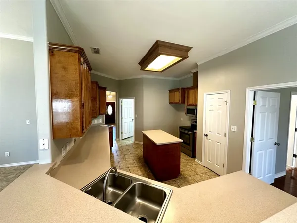 a kitchen with a refrigerator stove and microwave