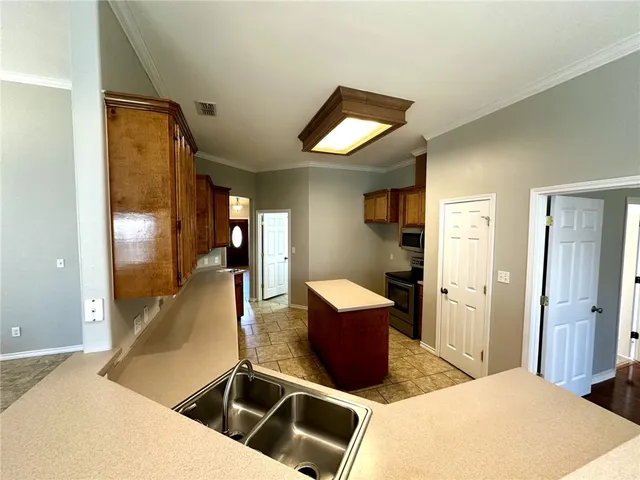 a kitchen with a refrigerator stove and microwave