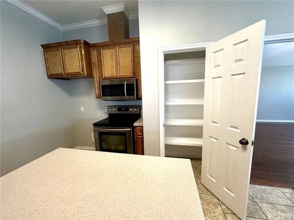 a large kitchen with stainless steel appliances granite countertop a stove a sink dishwasher and a refrigerator