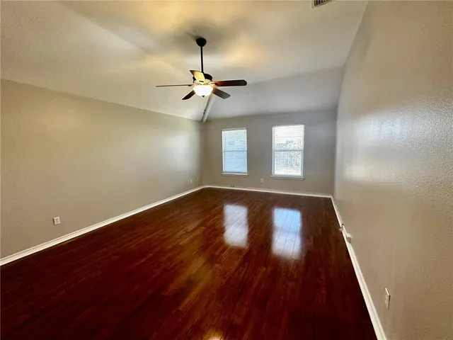 a spacious bathroom with a granite countertop sink and a mirror