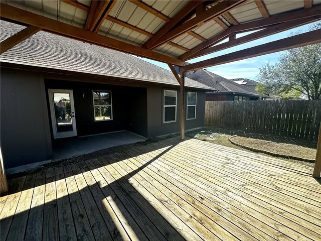 a view of a yard with wooden fence