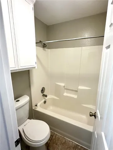 a bathroom with a toilet and a bathtub