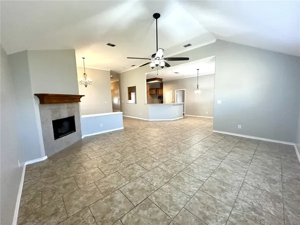 a view of a livingroom with wooden floor and a bathroom