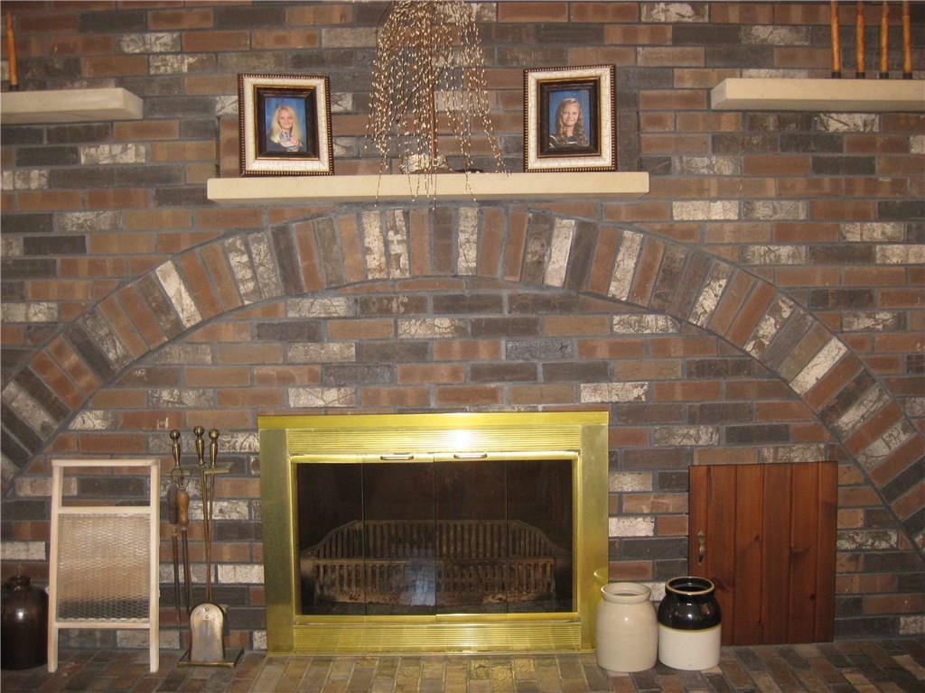 1475 Plain Grove Road Volant, PA 16156 - Photo 14 of 25 Wood burning functional fireplace in the living room. The brick covers the entire wall!