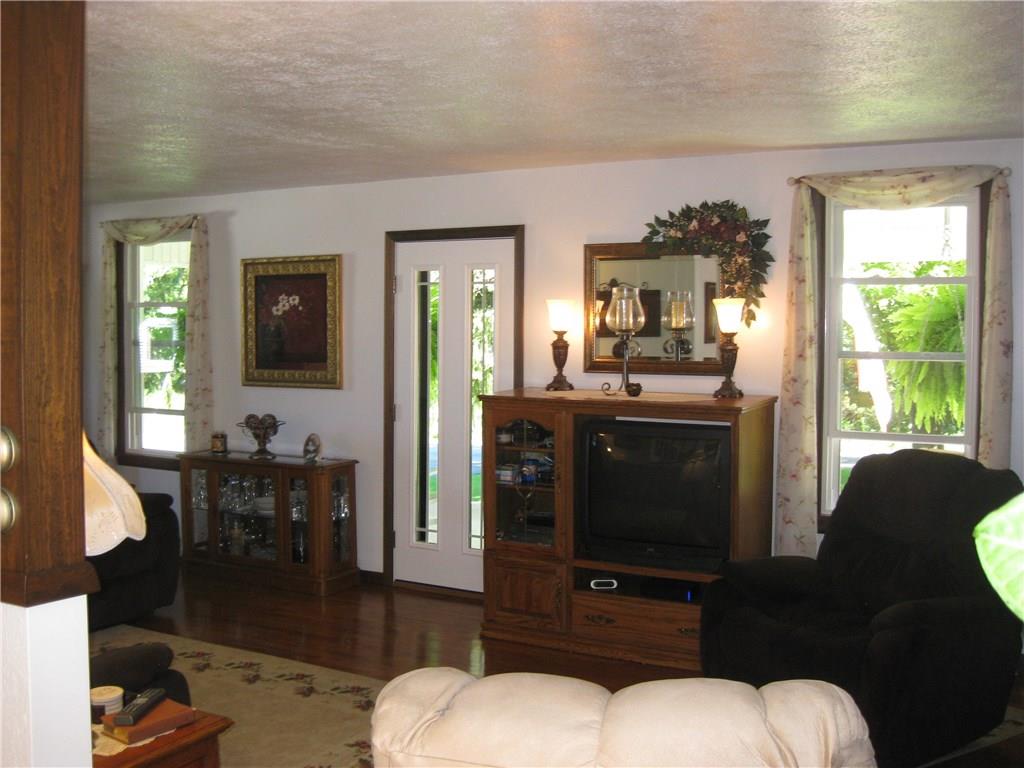 1475 Plain Grove Road Volant, PA 16156 - Photo 15 of 25 Living room view of front door and porch windows.