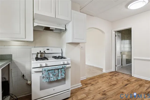 a kitchen with stainless steel appliances granite countertop a stove and a refrigerator