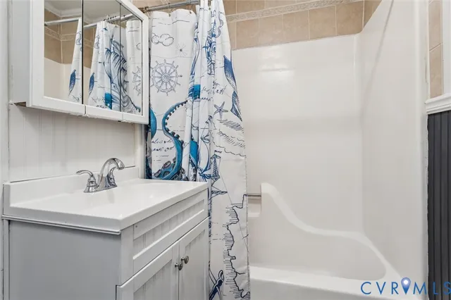 a bathroom with a sink a mirror and a bathtub