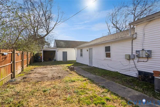 a view of a backyard with a large tree
