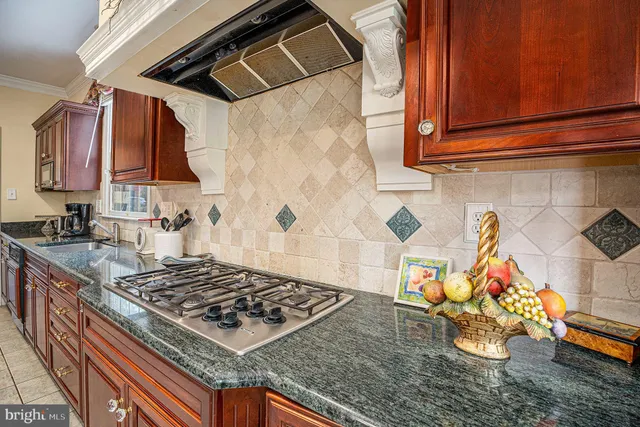 a stove top oven sitting inside of a kitchen