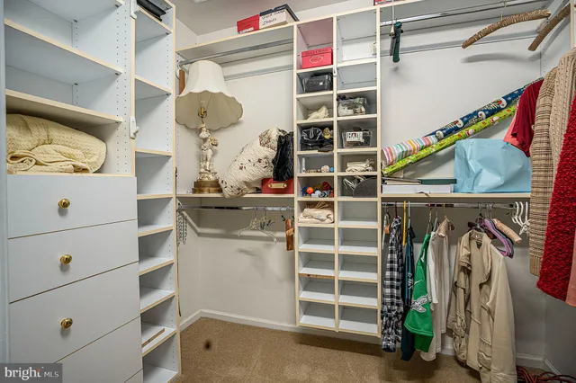 a spacious bathroom with a mirror a shower and a sink
