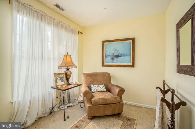 a bathroom with a granite countertop toilet sink and a window