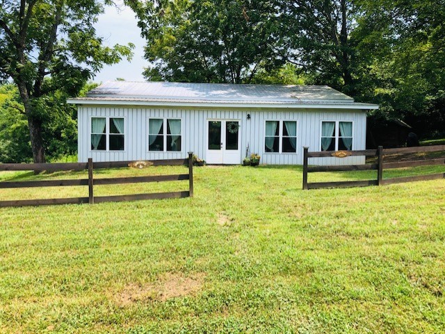 a view of a house with swimming pool and a yard