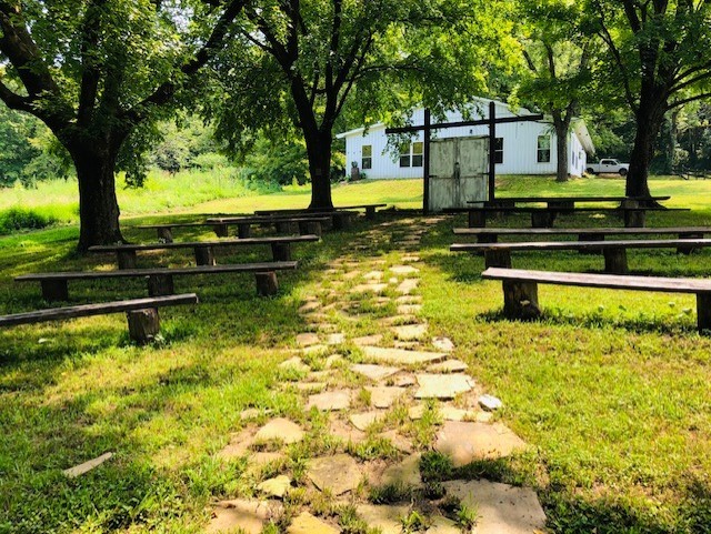 248 Access Road Pulaski, TN 38478 - Photo 5 of 19 a swimming pool that has lawn chairs under an trees