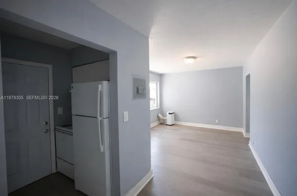 a view of a room with wooden floor