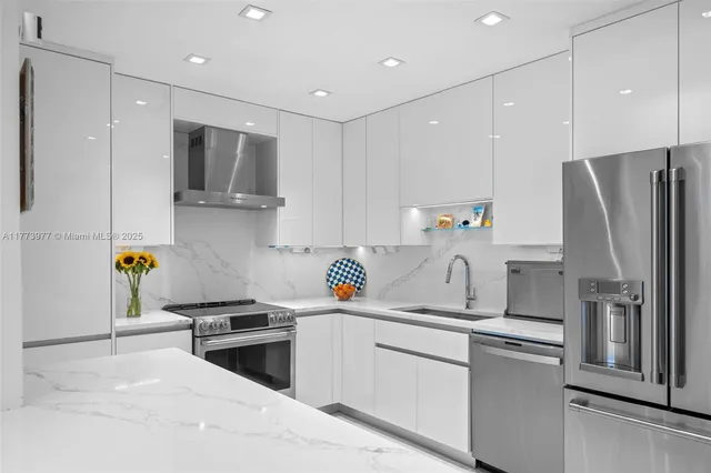 a kitchen with a sink stainless steel appliances and cabinets
