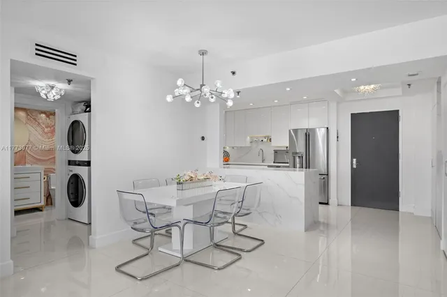 a view of a dining room with furniture and chandelier