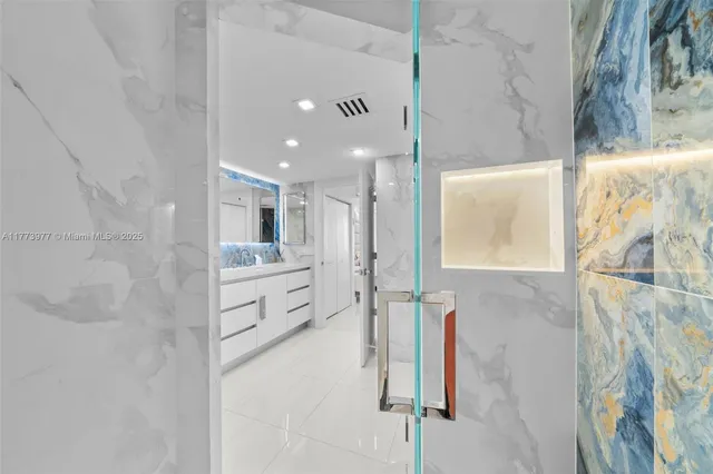 a bathroom with a double vanity sink a mirror and a shower