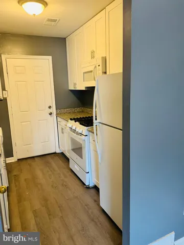 a kitchen with a white cabinets and a stove