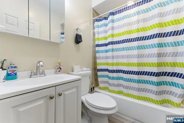 a bathroom with a sink a toilet and bathtub