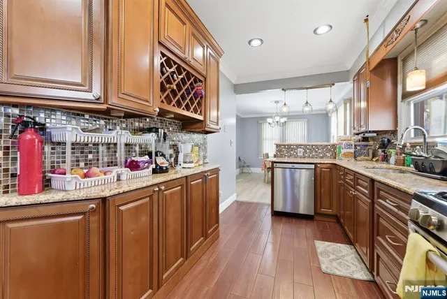 a kitchen with stainless steel appliances granite countertop a sink and cabinets
