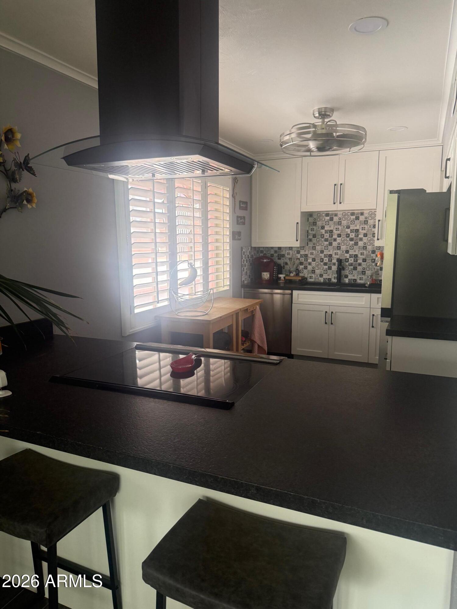 126 East Coronado Road, Unit 17 Phoenix, AZ 85004 - Photo 14 of 30 a kitchen with stainless steel appliances kitchen island granite countertop a refrigerator and a stove top oven