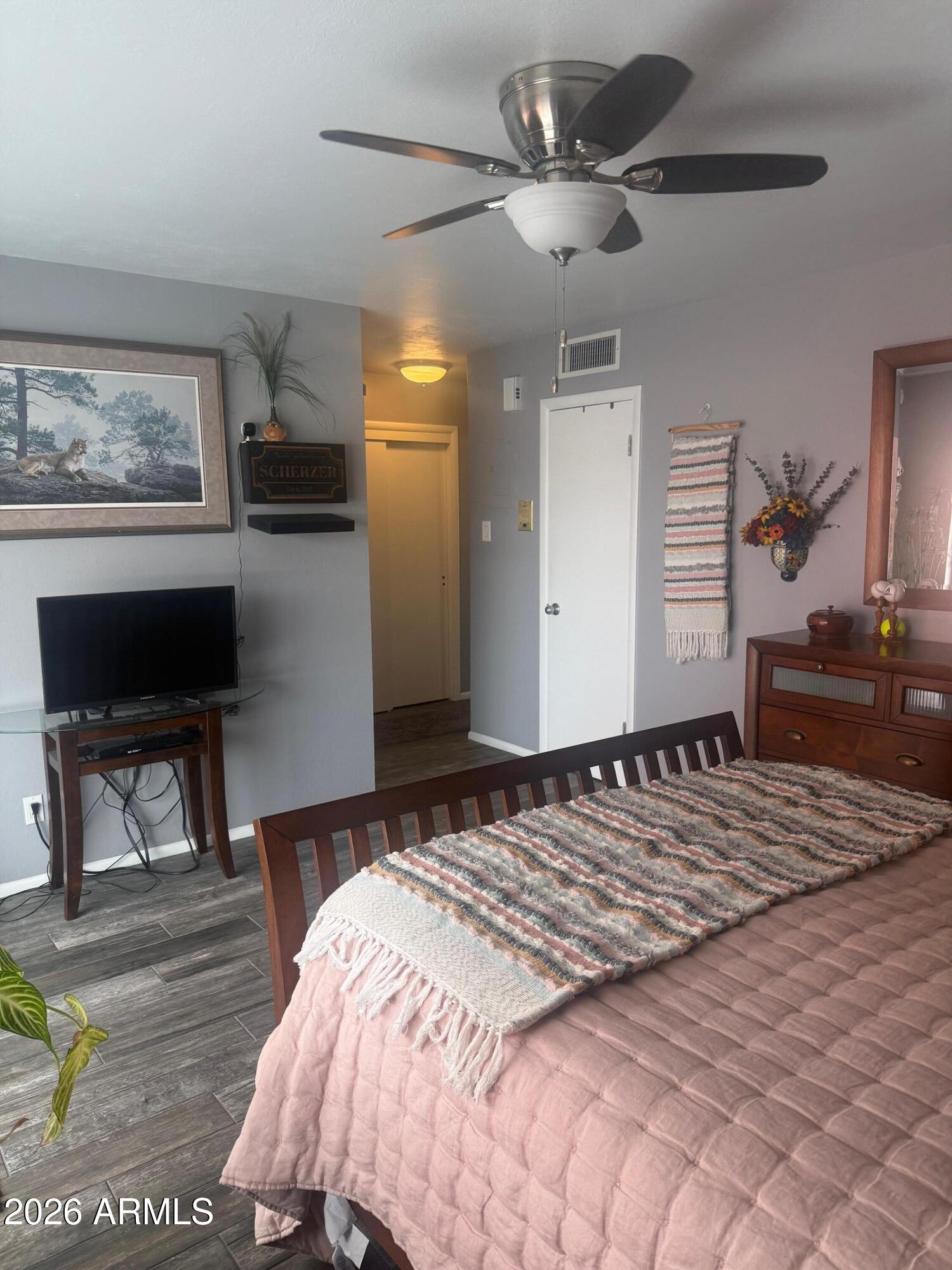 126 East Coronado Road, Unit 17 Phoenix, AZ 85004 - Photo 18 of 30 a bedroom with a bed a chair and potted plant on the dresser