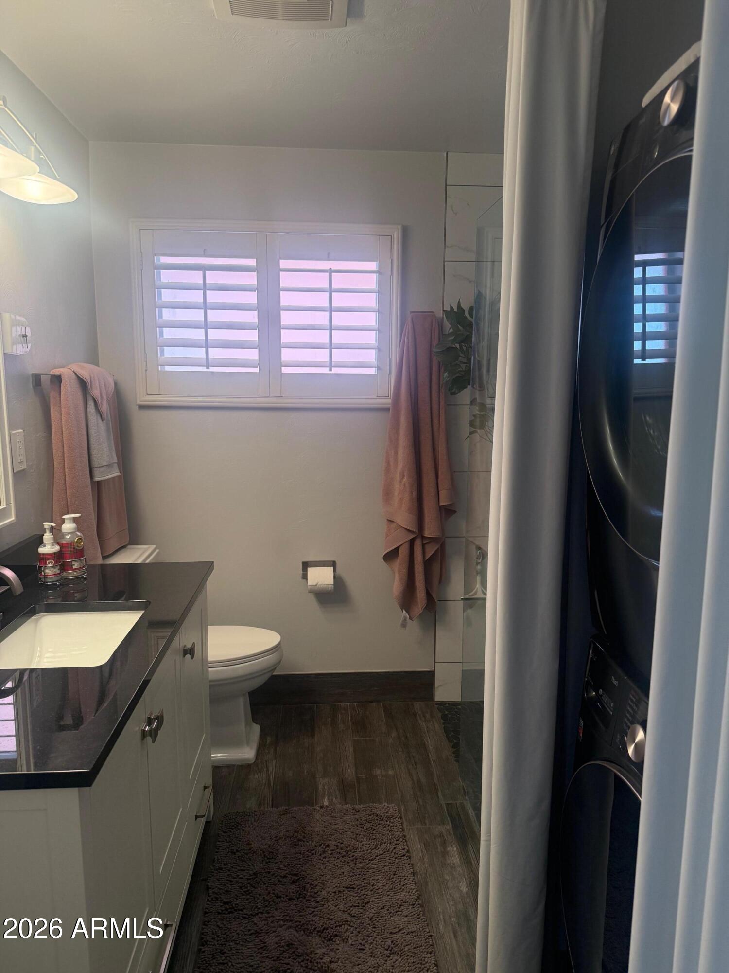 126 East Coronado Road, Unit 17 Phoenix, AZ 85004 - Photo 21 of 30 a bathroom with a granite countertop sink toilet and shower