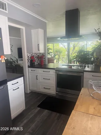 a kitchen with a sink and wooden cabinets