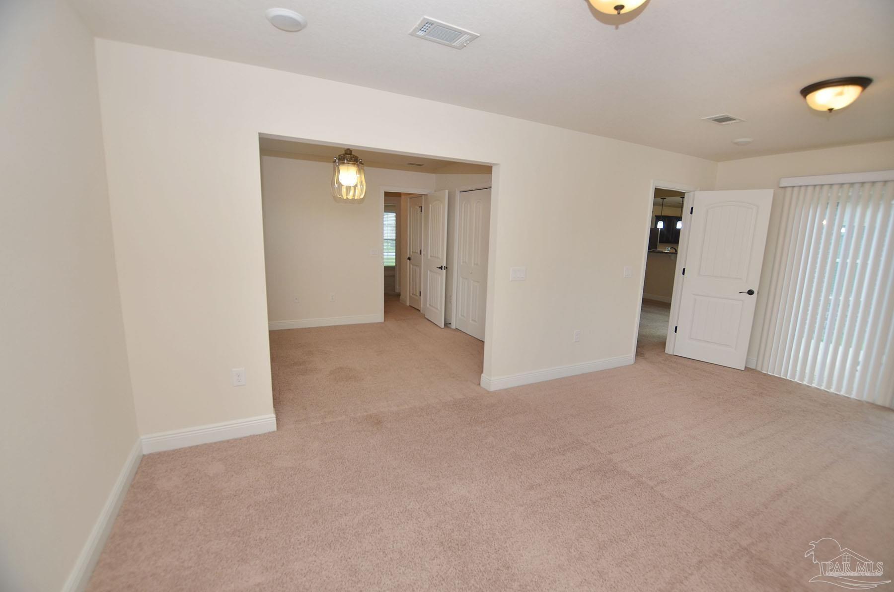 5709 Mill Stream Way Pace, FL 32571 - Photo 31 of 48 an empty room with closet and mirror